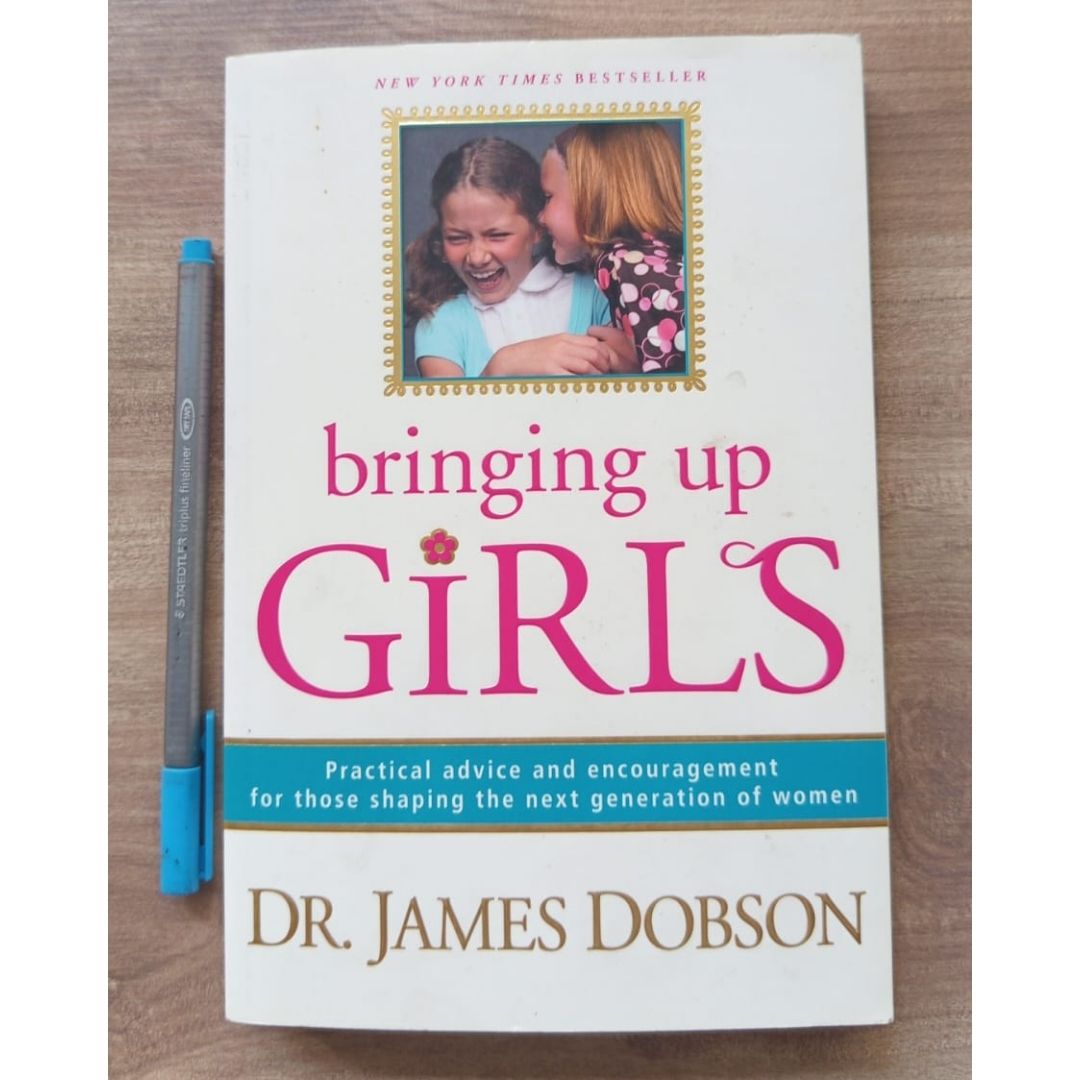Bringing Up Girls: Practical Advice and Encouragement for Those Shaping the Next Generation of Women (by James C. Dobson) (USED book, softcover, with slight folds on book cover)